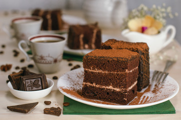 Still life on the table. Sweet cake and a hot drink . chocolate cake .