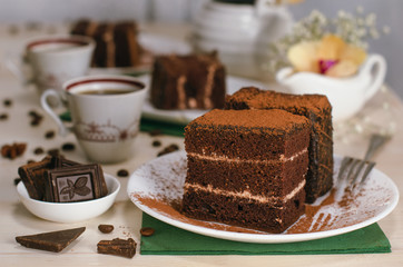 Still life on the table. Sweet cake and a hot drink . chocolate cake .