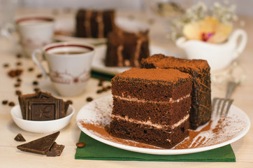 Still life on the table. Sweet cake and a hot drink . chocolate cake .