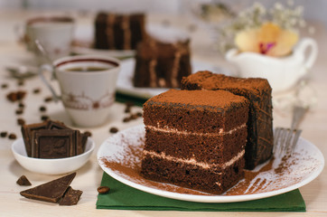 Still life on the table. Sweet cake and a hot drink . chocolate cake .