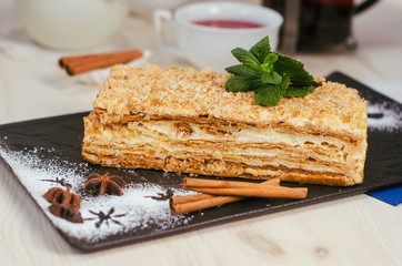 Still life on the table. Sweet cake grated pie and a hot drink .