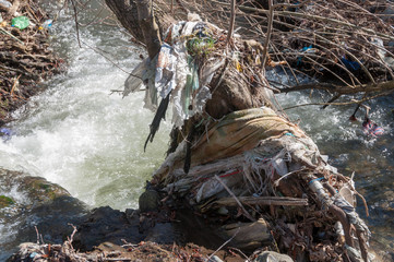 Plastic and foam garbage floating on the surface of the river