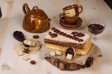 Still life on the table. Sweet cake and a hot drink .