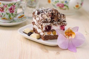 Still life on the table. Sweet cake and a hot drink .
