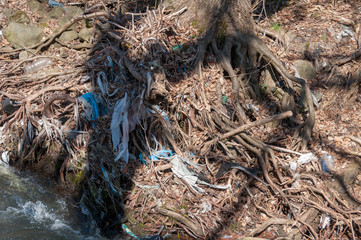 Plastic and foam garbage floating on the surface of the river