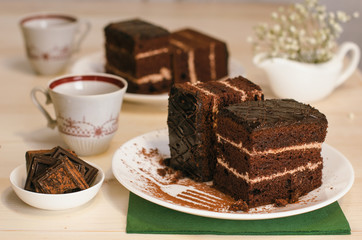 Still life on the table. Sweet cake and a hot drink . chocolate cake .
