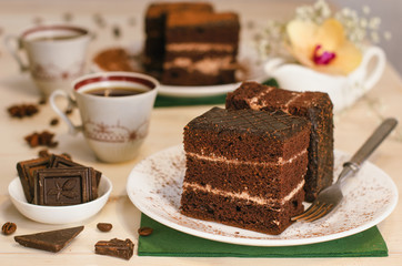 Still life on the table. Sweet cake and a hot drink . chocolate cake .