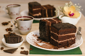Still life on the table. Sweet cake and a hot drink . chocolate cake .