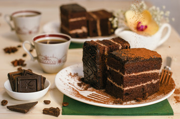 Still life on the table. Sweet cake and a hot drink . chocolate cake .