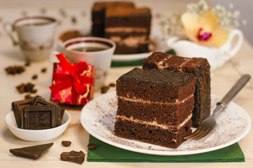 Still life on the table. Sweet cake and a hot drink . chocolate cake .