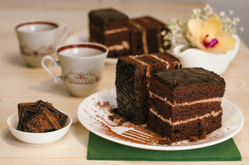 Still life on the table. Sweet cake and a hot drink . chocolate cake .