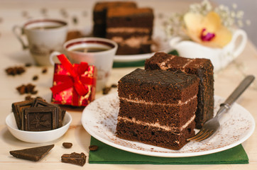 Still life on the table. Sweet cake and a hot drink . chocolate cake .