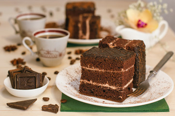 Still life on the table. Sweet cake and a hot drink . chocolate cake .