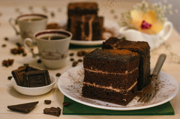 Still life on the table. Sweet cake and a hot drink . chocolate cake .