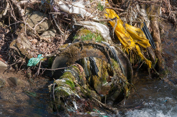 Plastic and foam garbage floating on the surface of the river