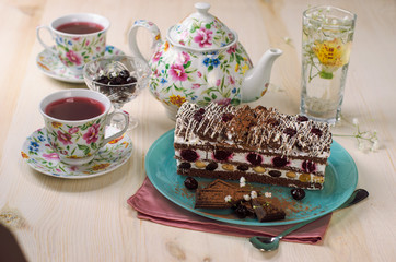 Still life on the table. Sweet cake and a hot drink .