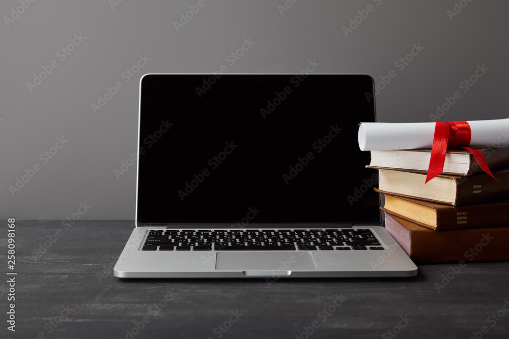 Wall mural Laptop with blank screen, diploma and books isolated on grey - Wall murals