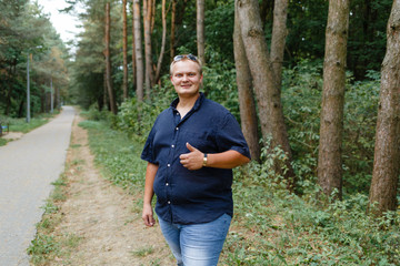 positive fat guy in the summer park