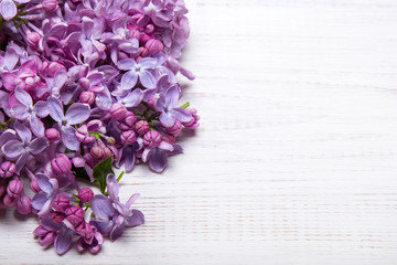 Lilac flowers on white wooden background, copy space,