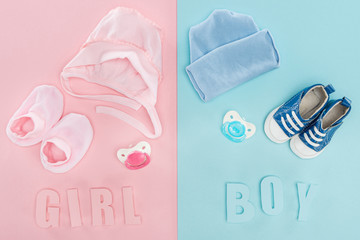 top view of pacifiers, hat, bonnet, booties,sneakers and boy, girl lettering