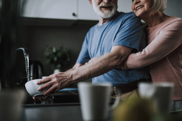 Senior couple enjoying time together on kitchen