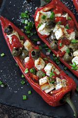 Red peppers stuffed with feta and olives. Baked paprika with olives and white cheese. Vegetarian food. Keto diet.