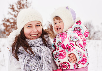 Happy mother and daughter spend time together on a winter day