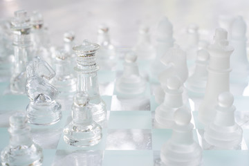 Chess board game made of glass, business competitive concept