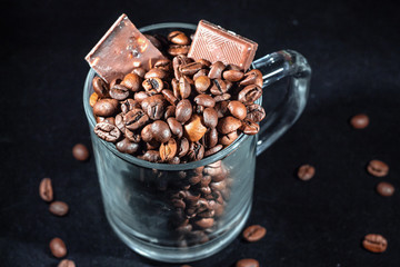 coffee grain and chocolate on dark background, close up