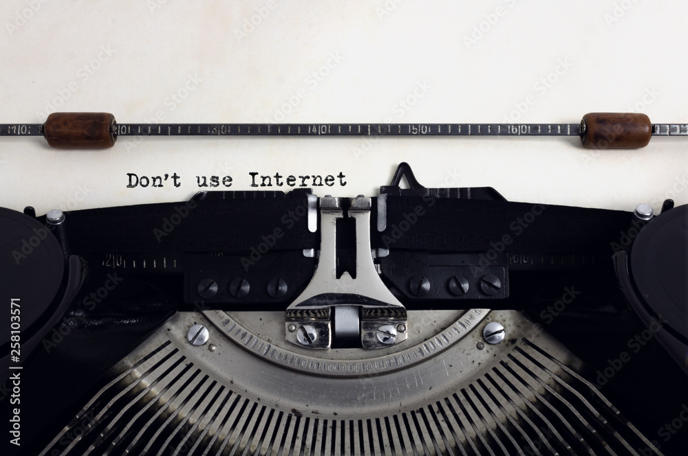Fototapete old retro vintage black typewriter with close-up typing text dont use internet as heading on aged pa