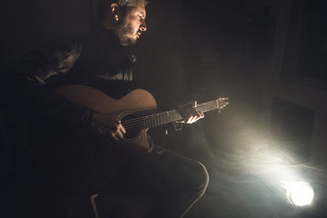 Man playing guitar. Guitarist on stage