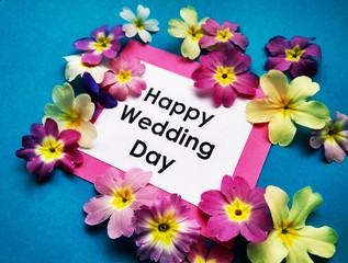 The inscription Happy Wedding Day with flowers on a colored background