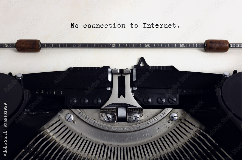 Fototapete old retro vintage black typewriter with close-up typing text no connection to internet as heading on