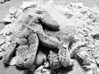 Repair - trimming foam and construction gloves on the tiled floor