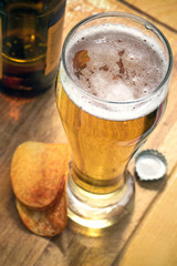 glass of beer with on a wooden stand