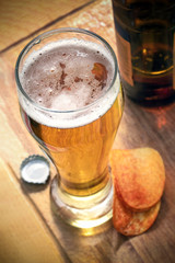 glass of beer with on a wooden stand