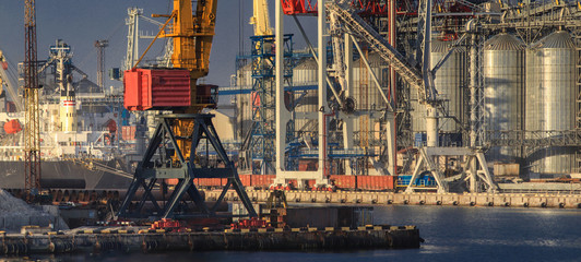 Lifting cargo cranes, ships and grain dryer in Sea Port of Odessa, Black Sea, Ukraine