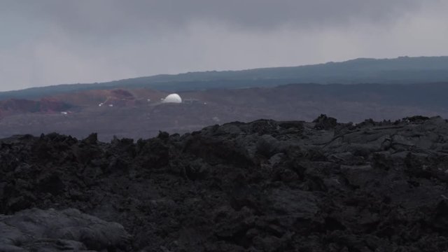 Desolate landscape in Hawaii with the Hi-Seas base in the background