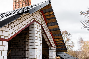 Construction of a pitched roof. Sheathing of metal roof. Roof slope.