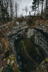 Woman explores the cave system Rakov Skocjan in Slovenia