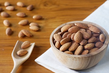 Almond nut in wood bowl on wooden table background