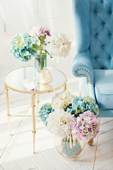 vintage blue sofa and bouquets of hydrangea