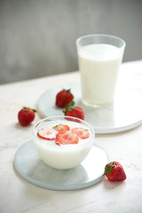 Fresh strawberry on a glass with dessert yogurt and strawberry  on white background