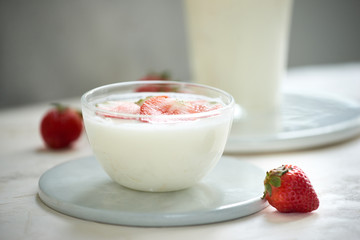 Fresh strawberry on a glass with dessert yogurt and strawberry  on white background