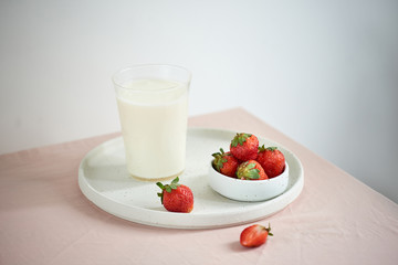 strawberry and yogurt on pink background