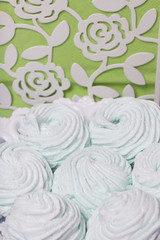 Fototapeta premium Homemade marshmallows laid on a plate. Marshmallow with mint, with a green tint. Nearby are napkins of light green color.