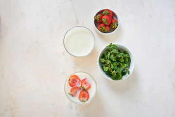Fresh cream dessert with raw organic strawberry on white board. French style yogurt