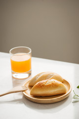 Morning breakfast with bread and orange juice.