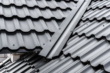 Construction of the roof of the house. Metal tiles. © Natallia