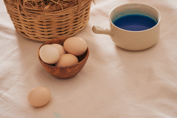Beautiful Easter composition with multicolored eggs and flowers on linen background